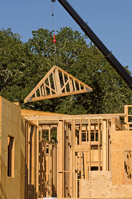 Crane lifting roof truss