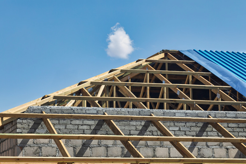 Workers building roof frame
